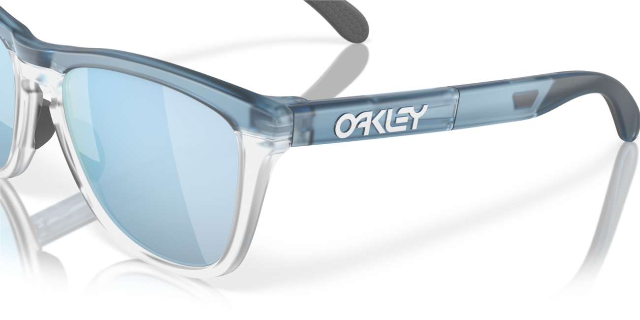 Oakley FROGSKINS RANGE слънчеви очила с рамка Trans каменно пране/прозрачен и со стъкла Prizm Deep Water Polarized, 55